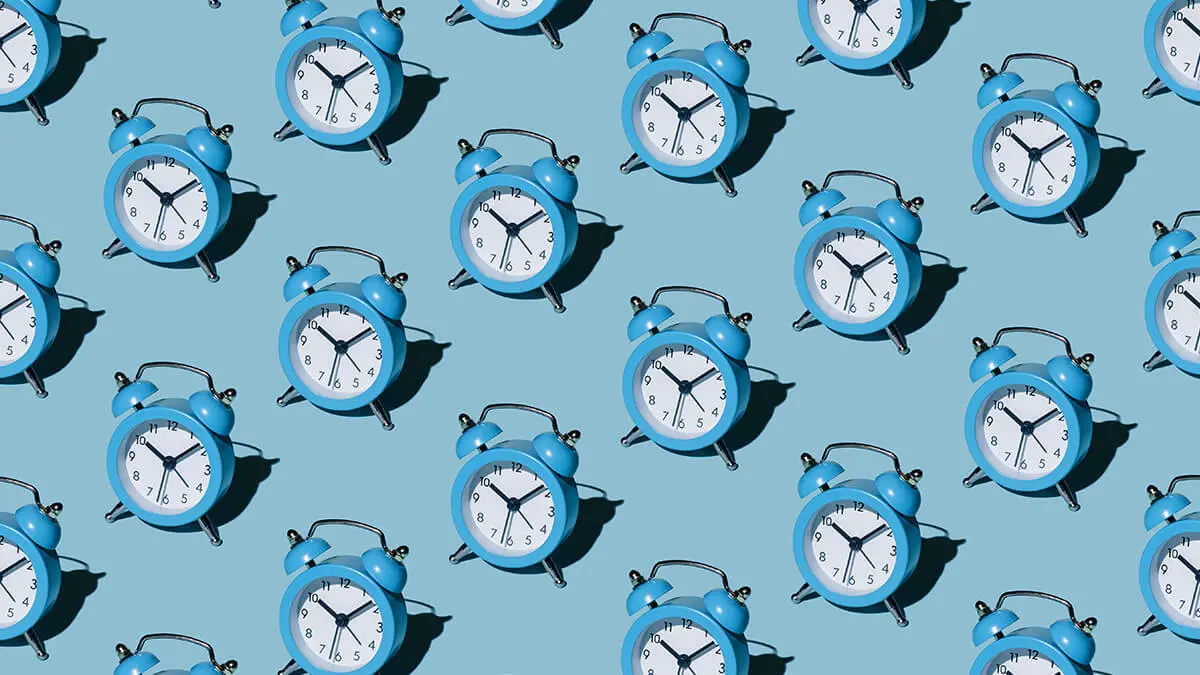 Rows of blue clocks on a blue background.