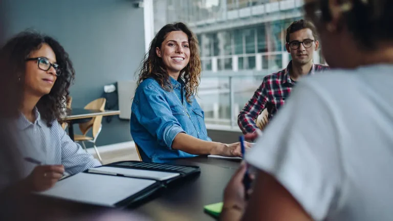 Employer and panel of employees interview a candidate for their growing business.