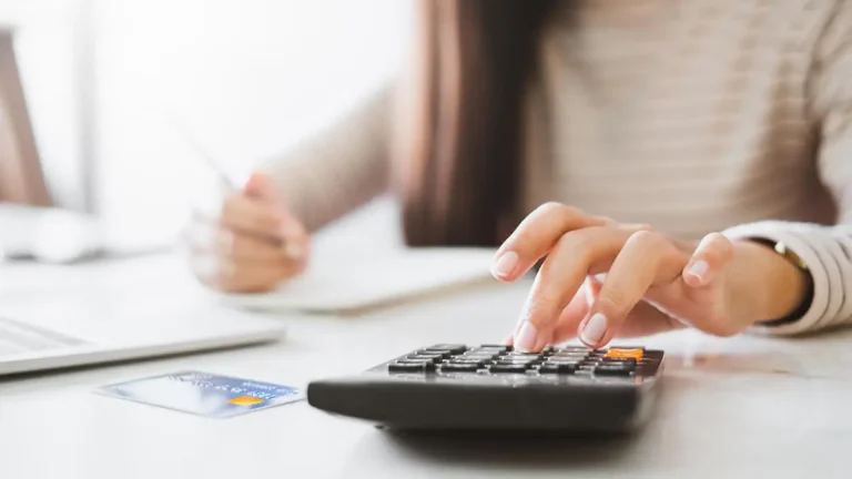 Business owner calculating payroll insurance costs.