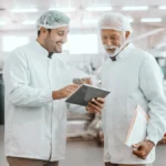 Two food workers reviewing the R&D tax credit.