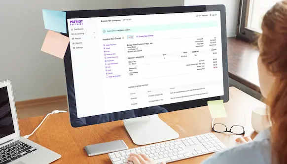 Woman using invoice detail screen to track payments.