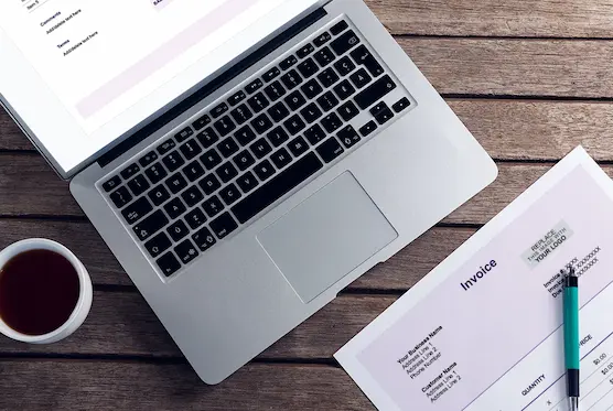 Screenshots of Patriot's free invoice on desk and laptop