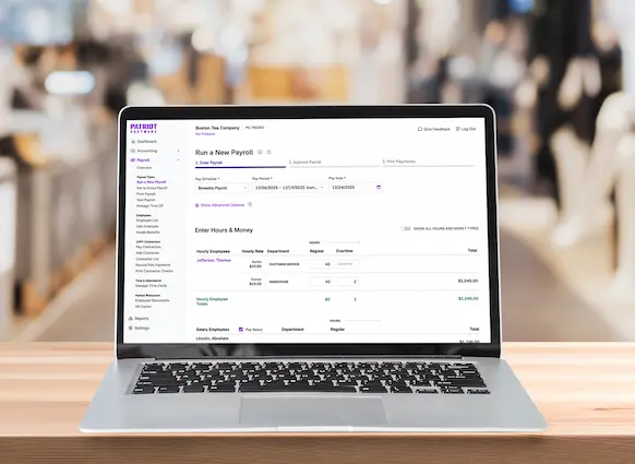 Patriot run payroll screen on laptop in retail setting