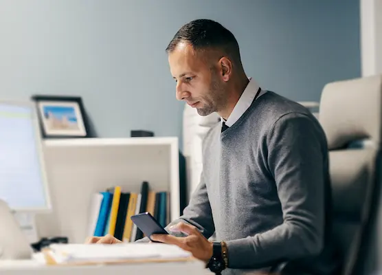 Man using laptop to run payroll
