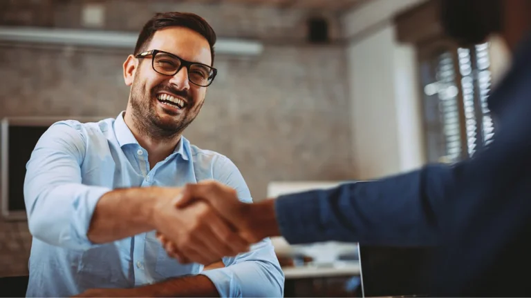 Accountant signing on a new client after explaining payroll service pricing.