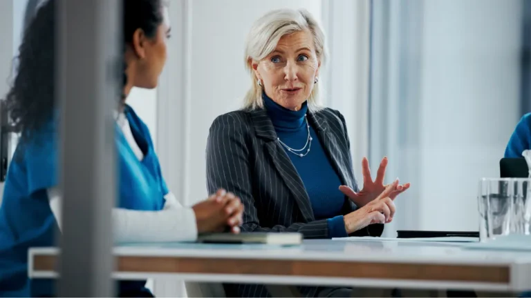 Payroll administrator speaking with a nurse.