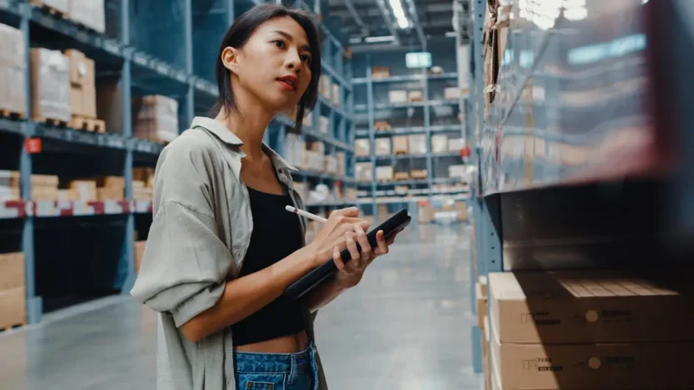 Woman taking inventory in a warehouse.