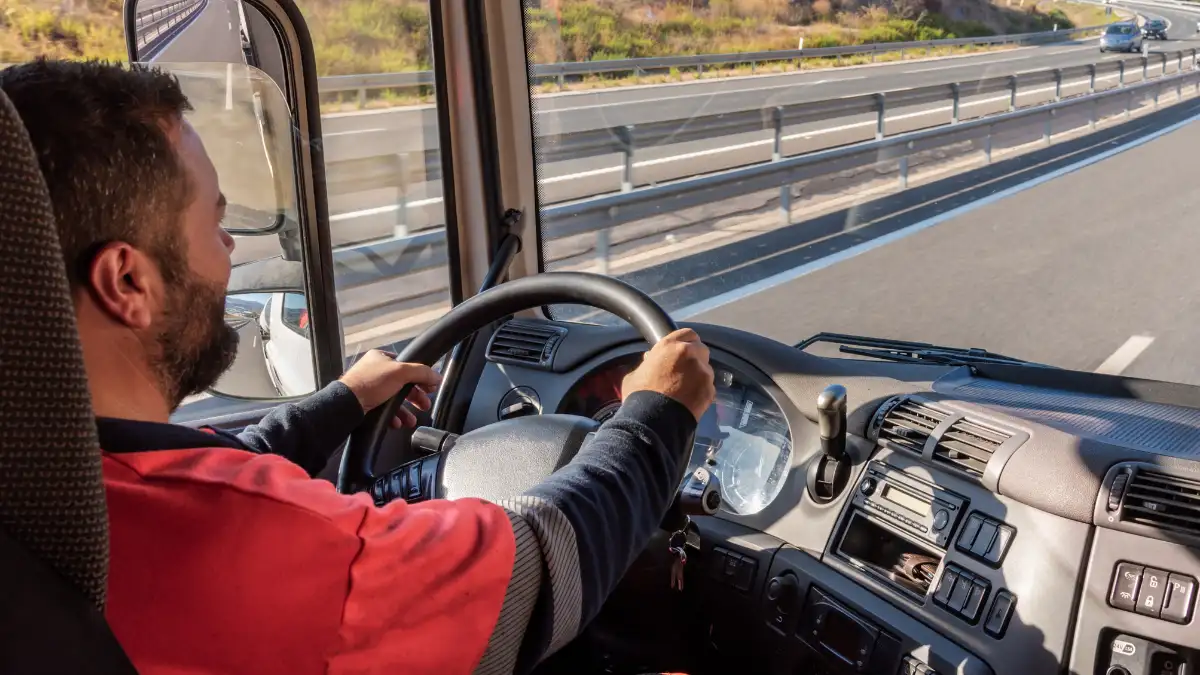 Employee driving a truck on the highway.