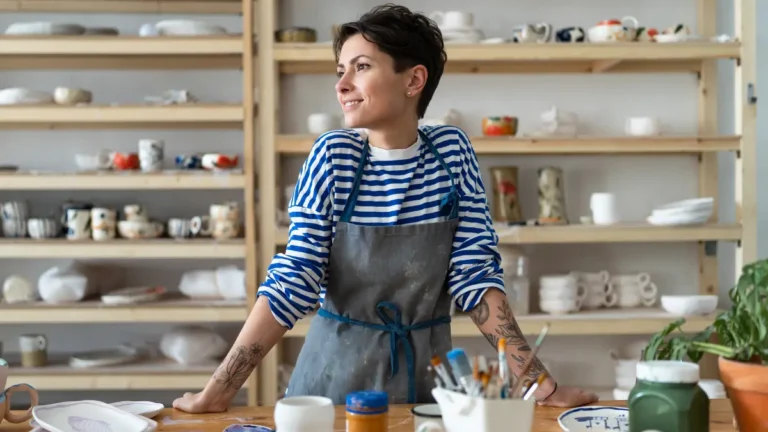 Relaxed business owner in her pottery shop.