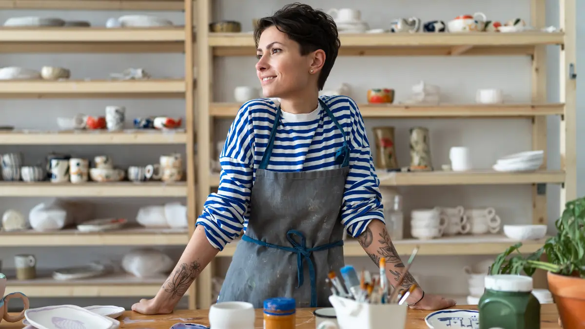 Relaxed business owner in her pottery shop.